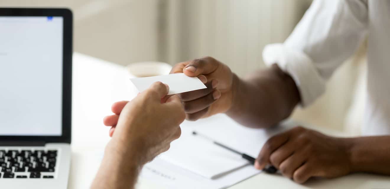 man handing out business card